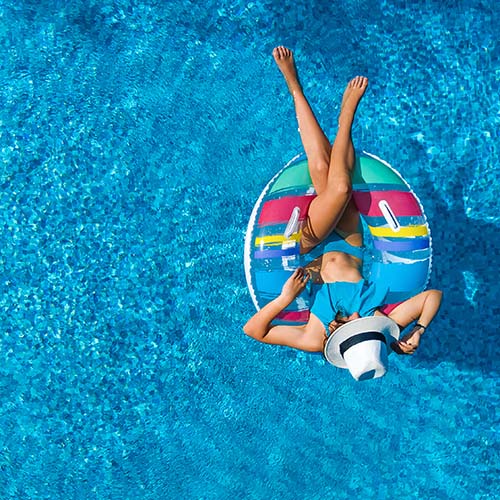 Woman Floating in Pool